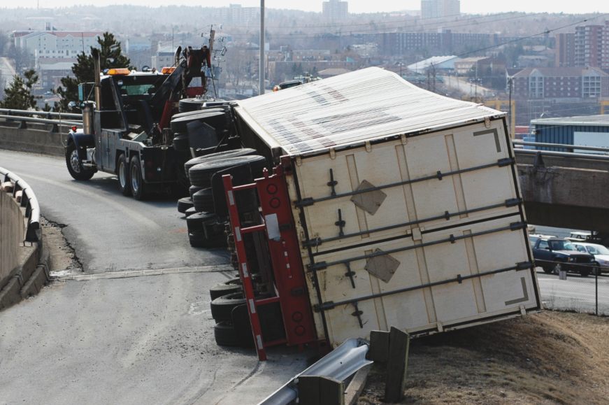 truck container fallen sidewise on the road