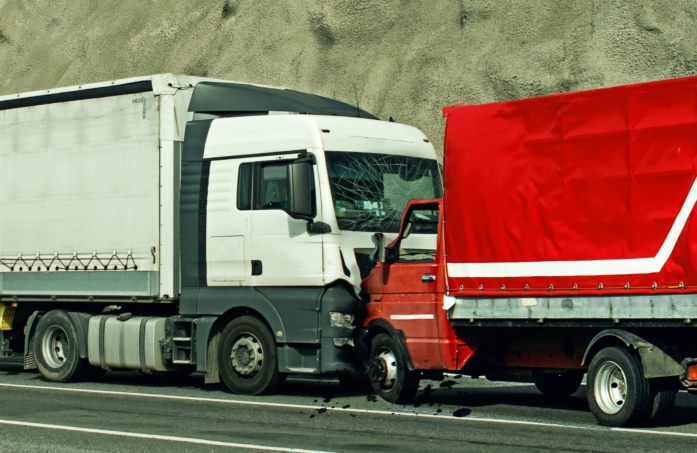 two trucks crashing on the highway