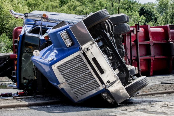 truck fallen upside down on the road